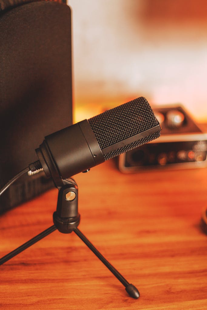 Close-up of a microphone setup in a warm-toned studio, ideal for podcasts and recordings.